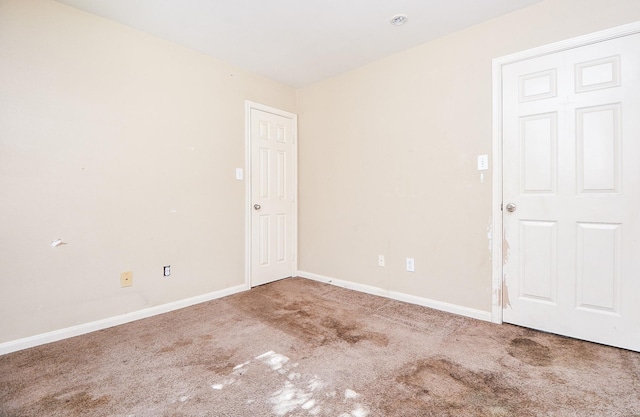 empty room with carpet flooring and baseboards