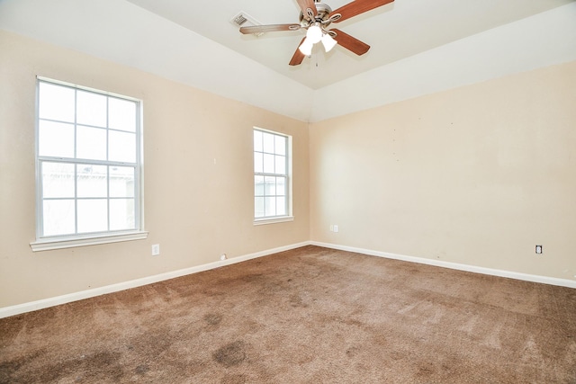 empty room with ceiling fan, lofted ceiling, and carpet flooring