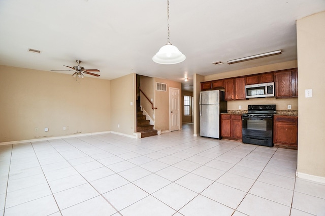 kitchen with hanging light fixtures, light tile patterned floors, stainless steel appliances, and ceiling fan