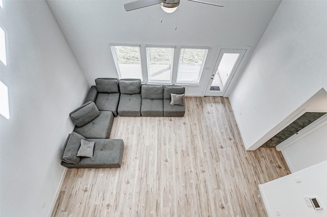 living room featuring ceiling fan and light hardwood / wood-style flooring