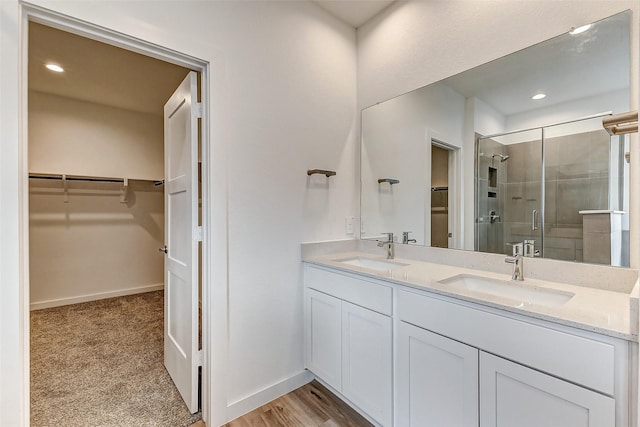 bathroom with an enclosed shower and vanity