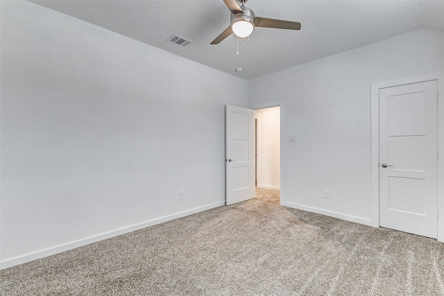 unfurnished room featuring ceiling fan, vaulted ceiling, and light carpet