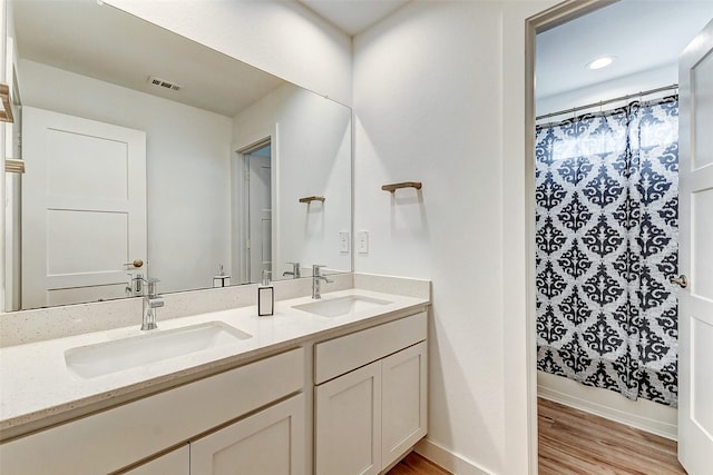 bathroom with vanity and hardwood / wood-style floors