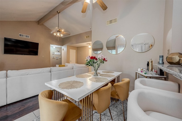 dining space featuring ceiling fan, high vaulted ceiling, hardwood / wood-style floors, and beamed ceiling