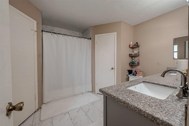 bathroom featuring vanity, a shower with curtain, and a textured ceiling