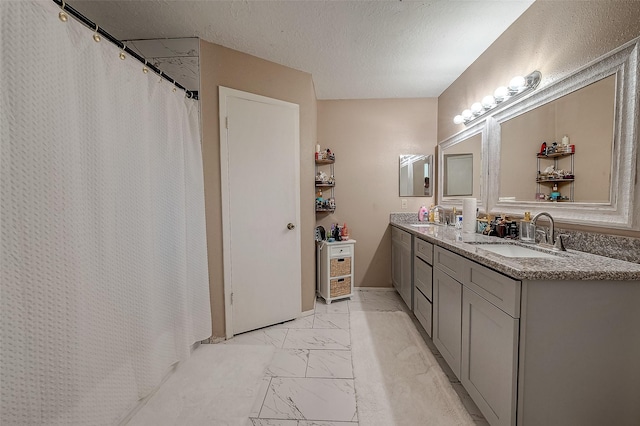 bathroom featuring vanity and a textured ceiling