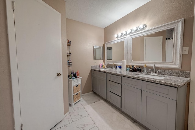 bathroom featuring vanity and a textured ceiling