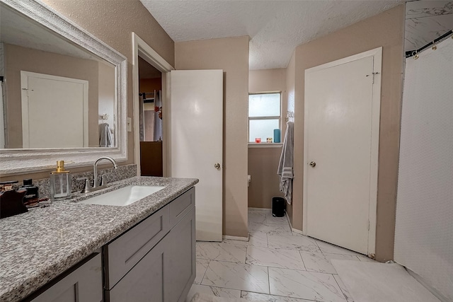 bathroom featuring vanity and a textured ceiling