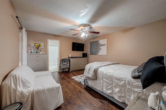 bedroom featuring ceiling fan, dark wood-type flooring, and a textured ceiling