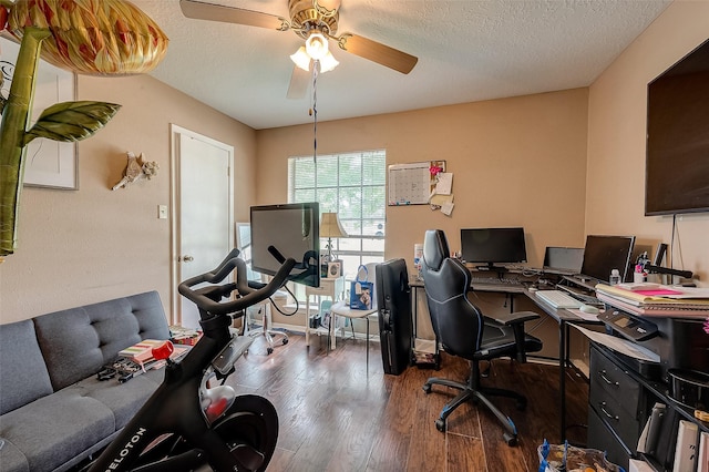 office area featuring ceiling fan, dark wood-type flooring, and a textured ceiling