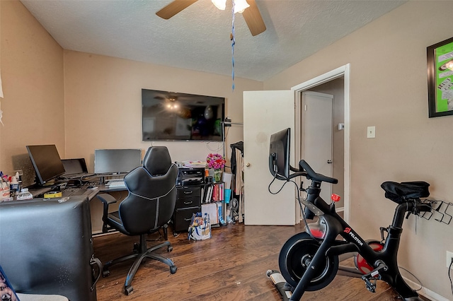 home office featuring ceiling fan, dark wood-type flooring, and a textured ceiling