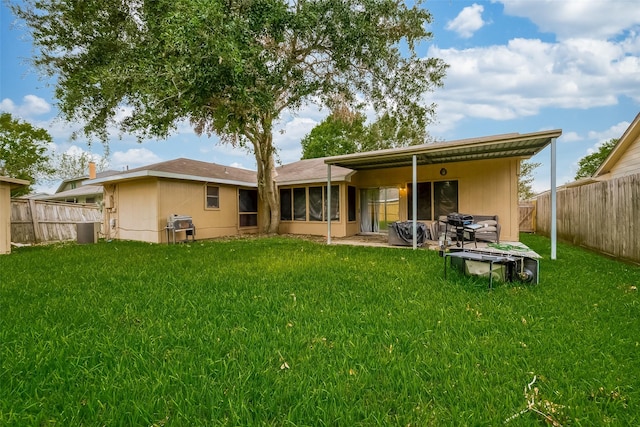 rear view of house featuring central AC, a lawn, and a patio area