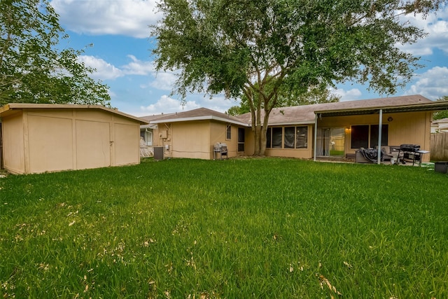 rear view of property featuring a yard