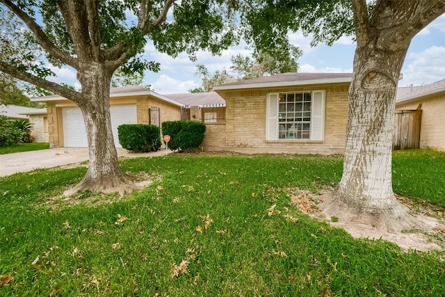 single story home featuring a garage and a front lawn