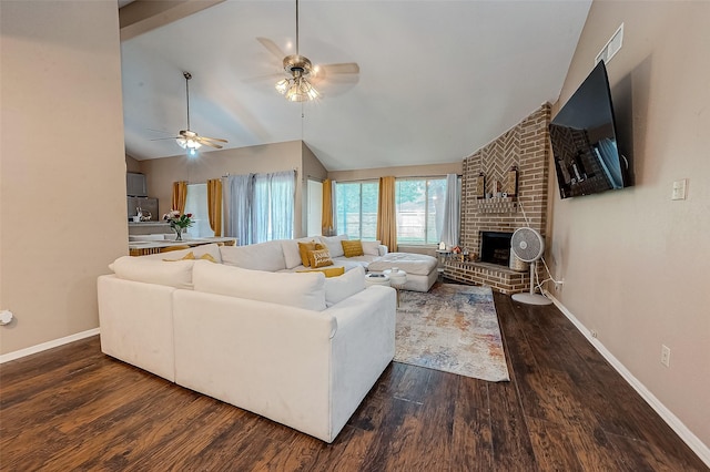 living room with vaulted ceiling, a brick fireplace, dark hardwood / wood-style floors, and ceiling fan