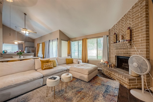 living room featuring hardwood / wood-style floors, vaulted ceiling, and a brick fireplace