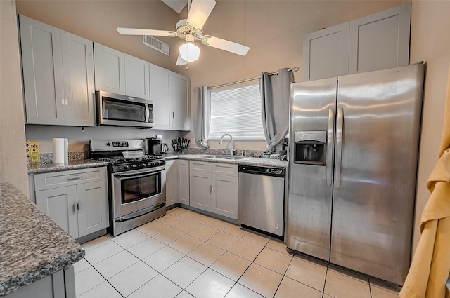 kitchen featuring stainless steel appliances, light tile patterned flooring, sink, and ceiling fan