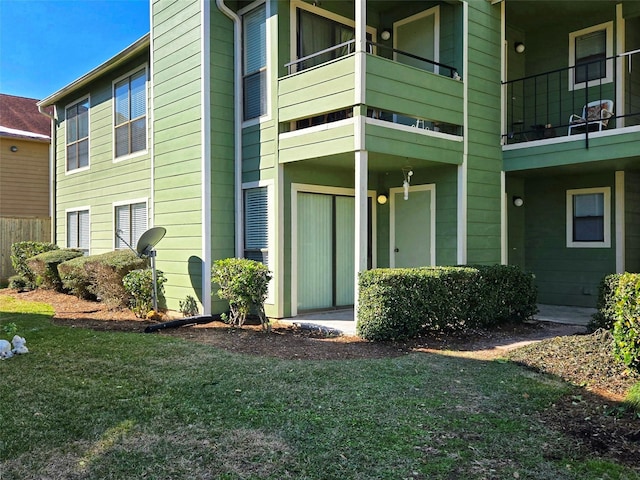 view of exterior entry featuring a yard