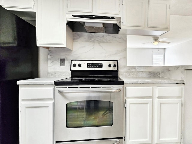 kitchen featuring black refrigerator, white cabinets, stainless steel range with electric cooktop, backsplash, and ceiling fan