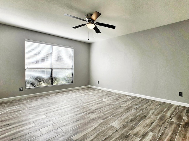 unfurnished room with ceiling fan and light hardwood / wood-style flooring