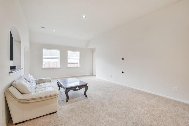 living area featuring light carpet