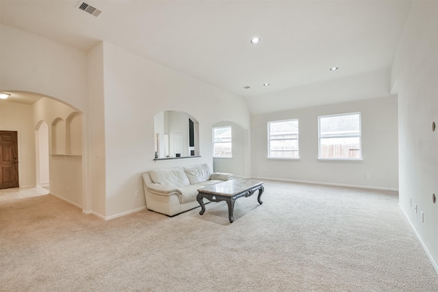 living room with light carpet and vaulted ceiling