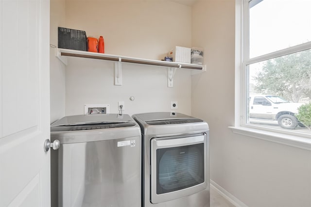 clothes washing area with separate washer and dryer