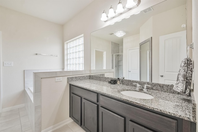 bathroom featuring tile patterned floors, a shower with door, and vanity