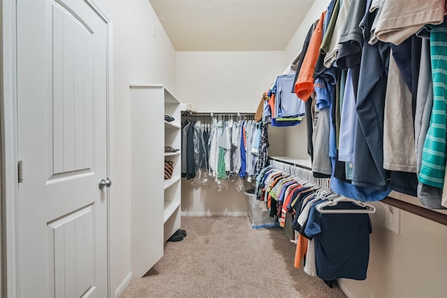 spacious closet featuring light carpet