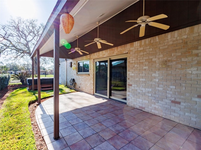 view of patio / terrace featuring a hot tub and ceiling fan