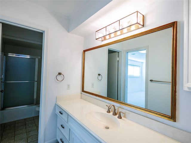 full bathroom featuring toilet, vanity, and shower / bath combination with glass door