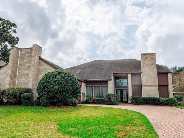 view of front of home with a front yard and french doors