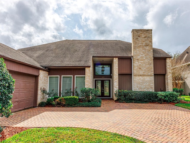 view of front of property featuring french doors and a garage