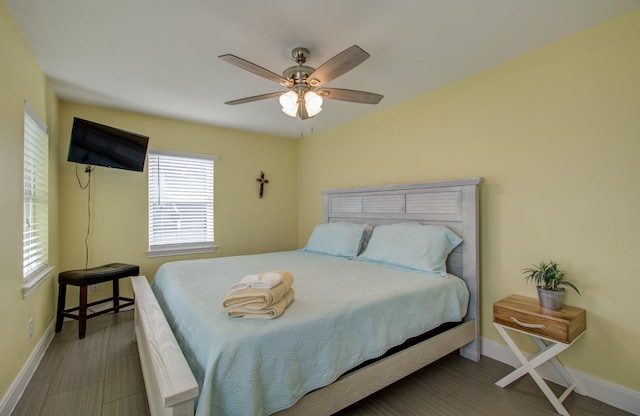 bedroom with ceiling fan and dark hardwood / wood-style floors