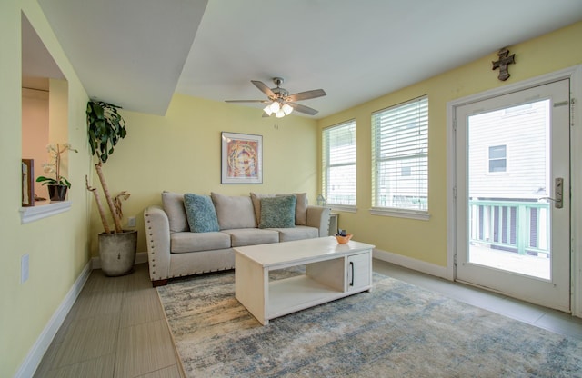 tiled living room with ceiling fan