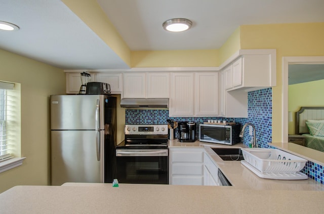 kitchen featuring appliances with stainless steel finishes, sink, decorative backsplash, and white cabinets