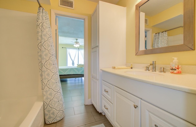 bathroom featuring vanity, ceiling fan, and shower / tub combo with curtain