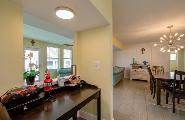 dining room with ceiling fan with notable chandelier and a wealth of natural light