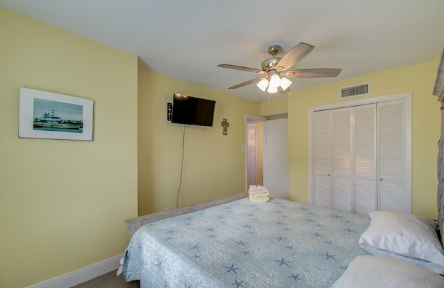 bedroom with ceiling fan and a closet