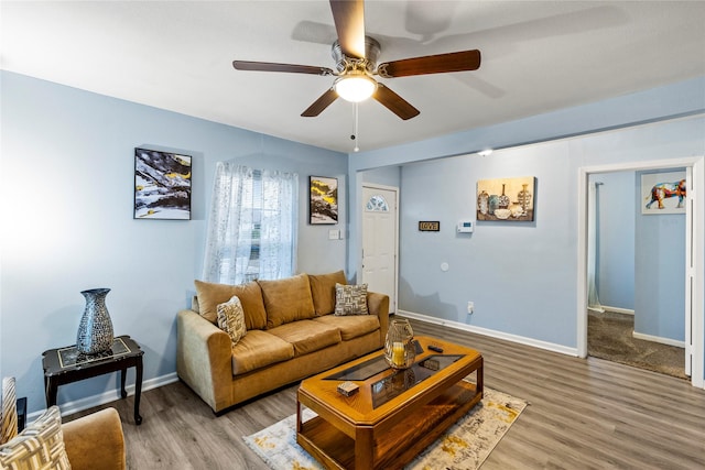 living room with light hardwood / wood-style floors and ceiling fan