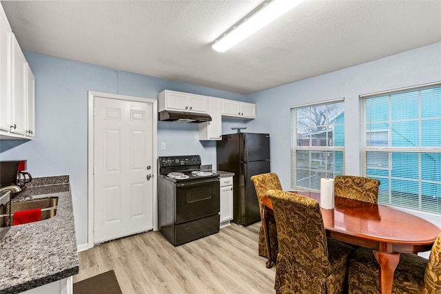 kitchen with black appliances, white cabinetry, sink, light stone counters, and light hardwood / wood-style floors