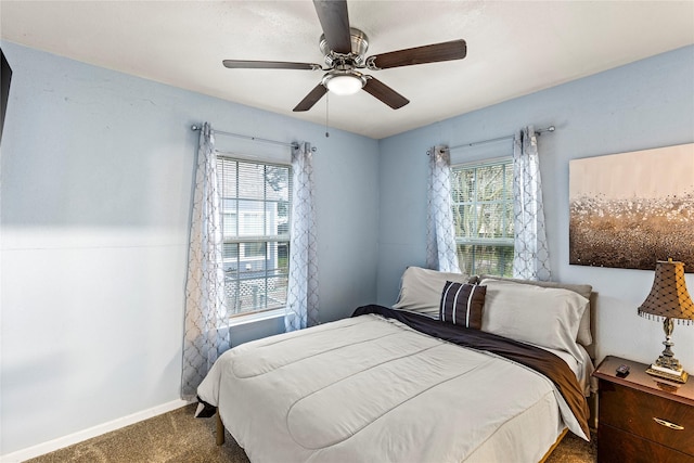 carpeted bedroom featuring multiple windows and ceiling fan