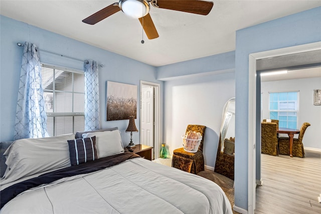 bedroom with hardwood / wood-style flooring and ceiling fan