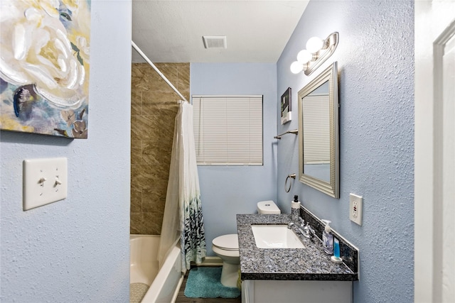 full bathroom with vanity, shower / tub combo, and toilet