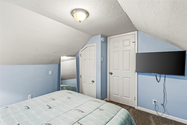 carpeted bedroom featuring lofted ceiling and a textured ceiling