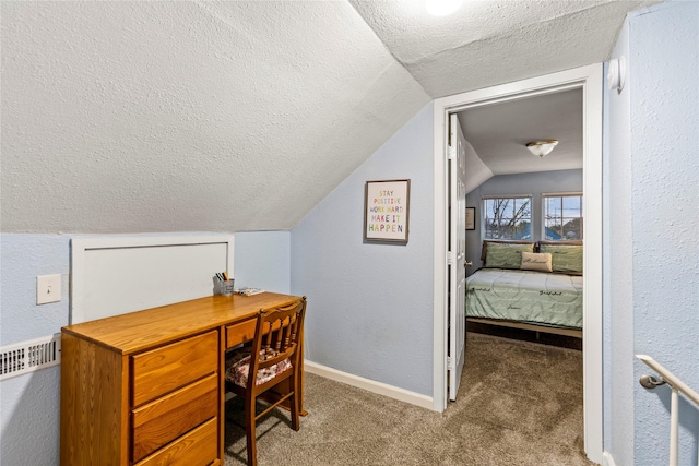 carpeted office with lofted ceiling, radiator, and a textured ceiling