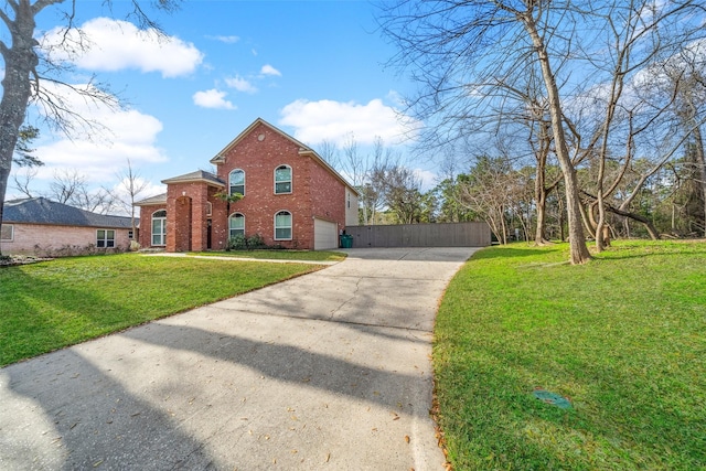 view of front of home featuring driveway, a garage, a front yard, and brick siding