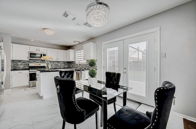 dining room featuring visible vents, baseboards, an inviting chandelier, french doors, and marble finish floor