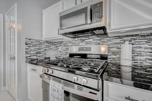 kitchen featuring white cabinetry, stainless steel appliances, and backsplash