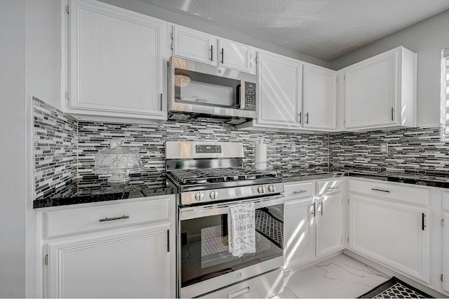 kitchen with stainless steel appliances, decorative backsplash, white cabinets, and marble finish floor